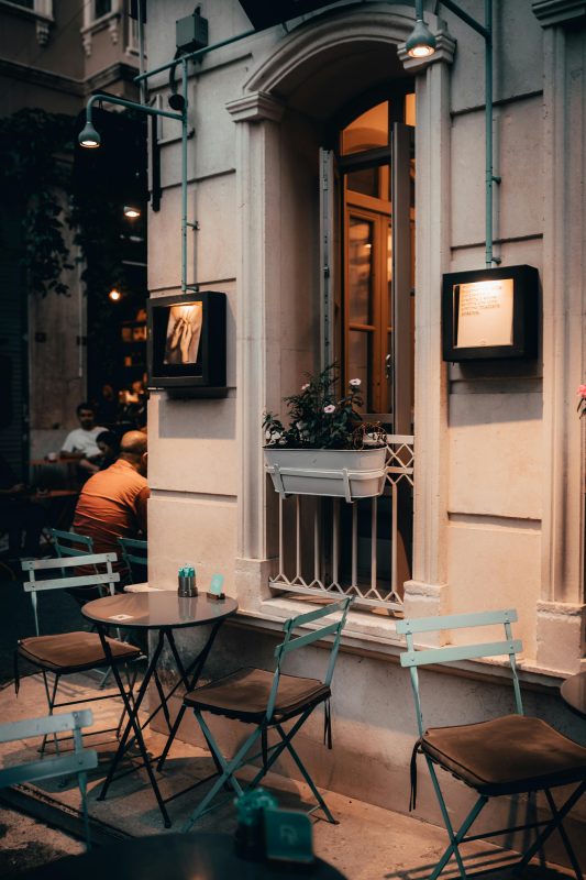 Outdoor seating area of a cafe at dusk - Shop C2CLights.com.